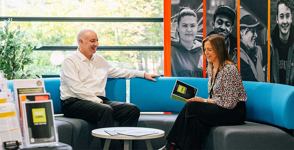 A member of the adult advice team talking to an adult student